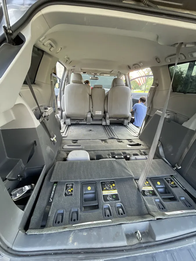 Minivan with the seats folded and the floor bins opened up for a full interior detail