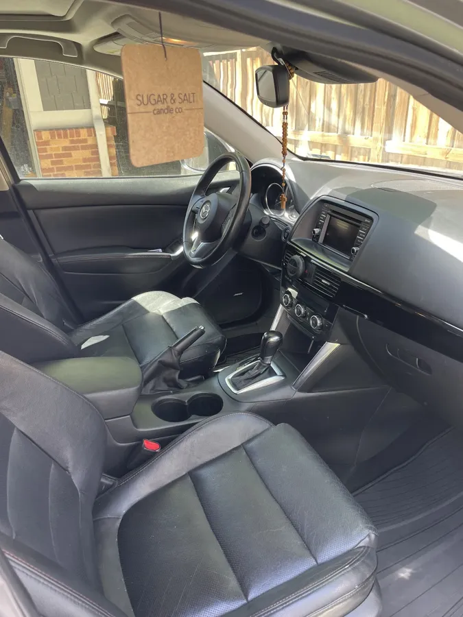 Front seats and center console after an interior detail by Wheely Clean